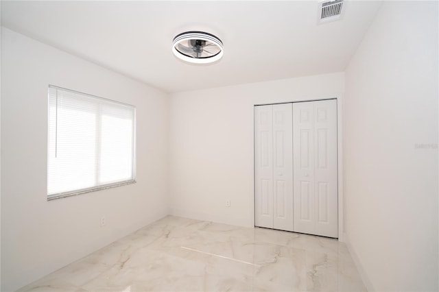 unfurnished bedroom featuring a closet