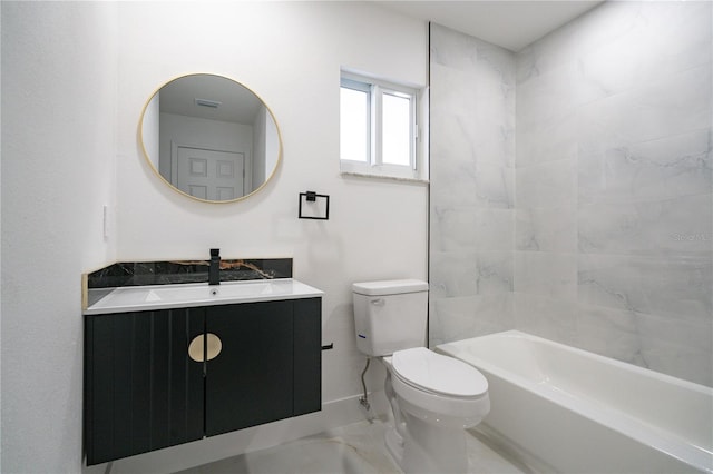 full bathroom with vanity, tiled shower / bath, and toilet