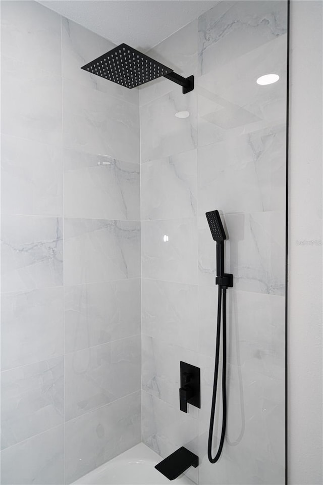 bathroom with tiled shower