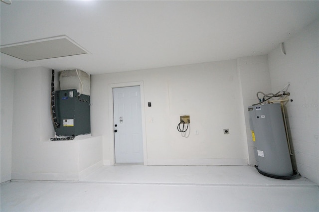 garage featuring water heater and heating unit