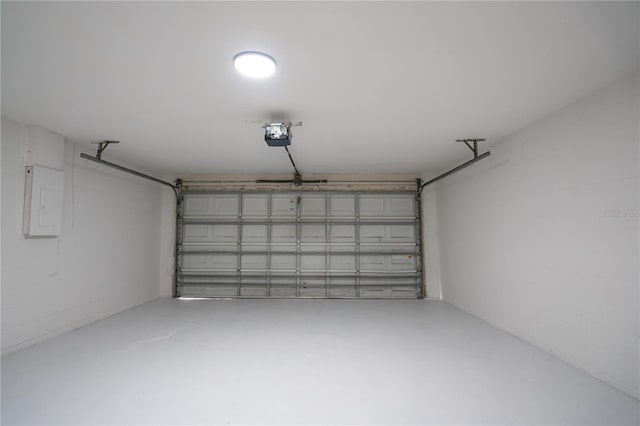 garage with a garage door opener and electric panel