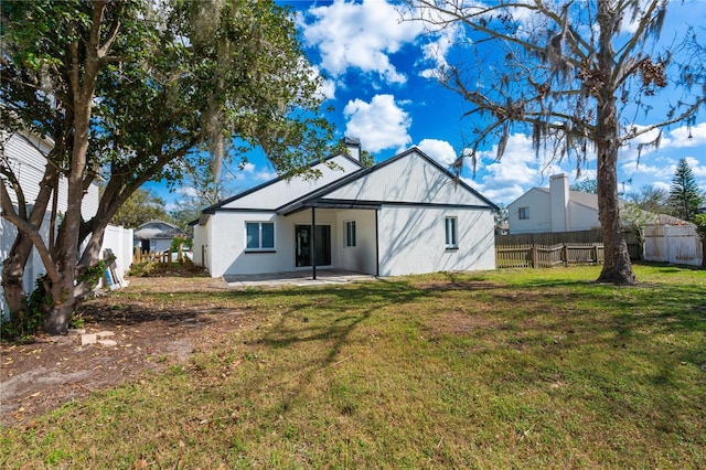 rear view of house with a yard and a patio area