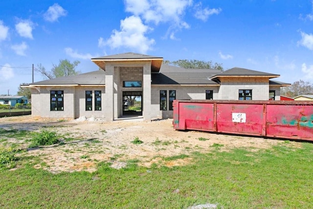 back of house with a lawn