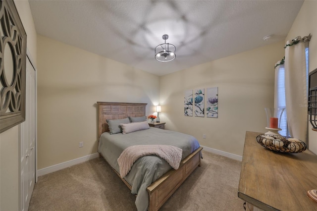 carpeted bedroom featuring a textured ceiling