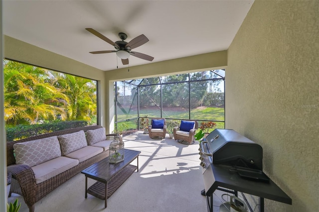 sunroom / solarium featuring ceiling fan