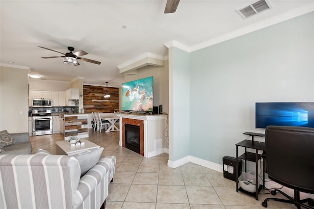 living room with ceiling fan, light tile patterned floors, and crown molding