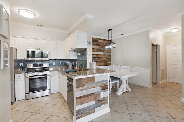 kitchen featuring stainless steel appliances, light tile patterned floors, sink, white cabinetry, and kitchen peninsula