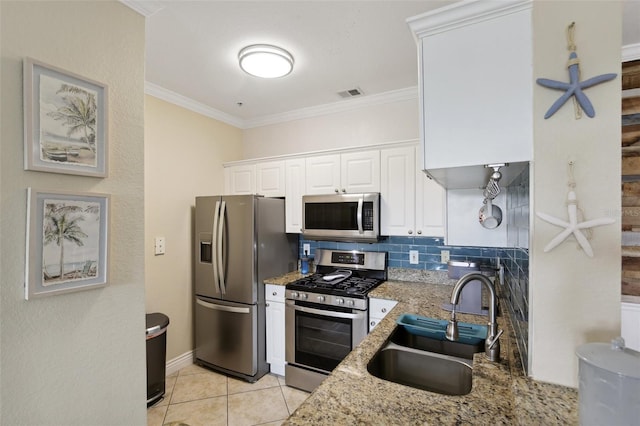 kitchen with stainless steel appliances, sink, backsplash, white cabinets, and crown molding
