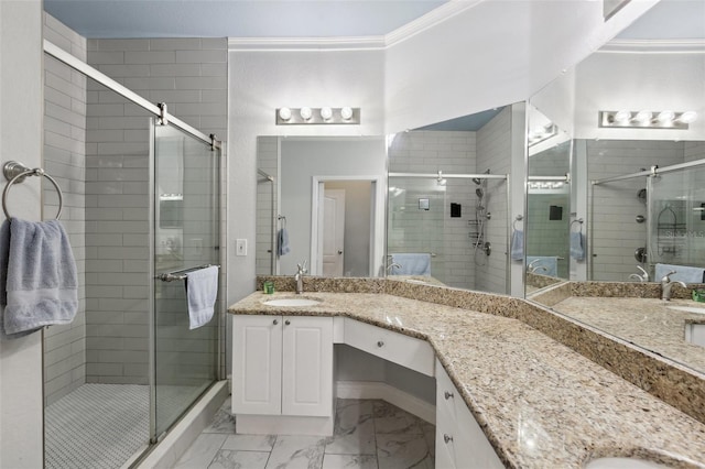 bathroom featuring vanity, ornamental molding, and a shower with door