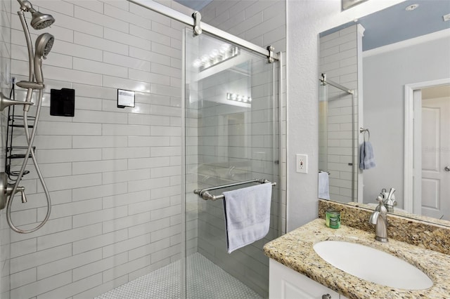 bathroom featuring crown molding, vanity, and a shower with door