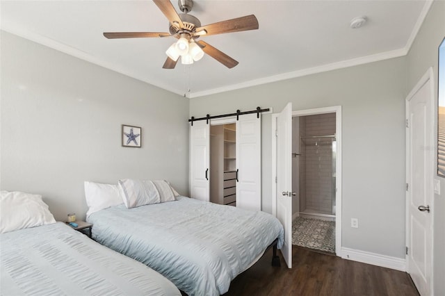 bedroom with ensuite bathroom, ceiling fan, dark wood-type flooring, a barn door, and ornamental molding