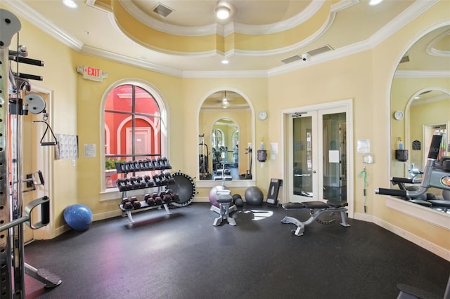 workout area with french doors, crown molding, and a raised ceiling