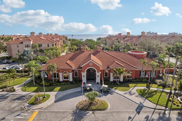 mediterranean / spanish-style house featuring a front lawn
