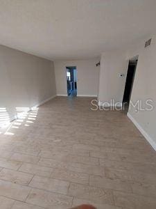 spare room featuring baseboards