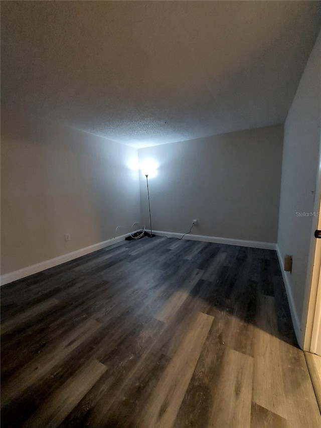 10033 64th Ave N Unit 9, Saint Petersburg, FL 33708 - empty room featuring dark wood finished floors and a textured ceiling