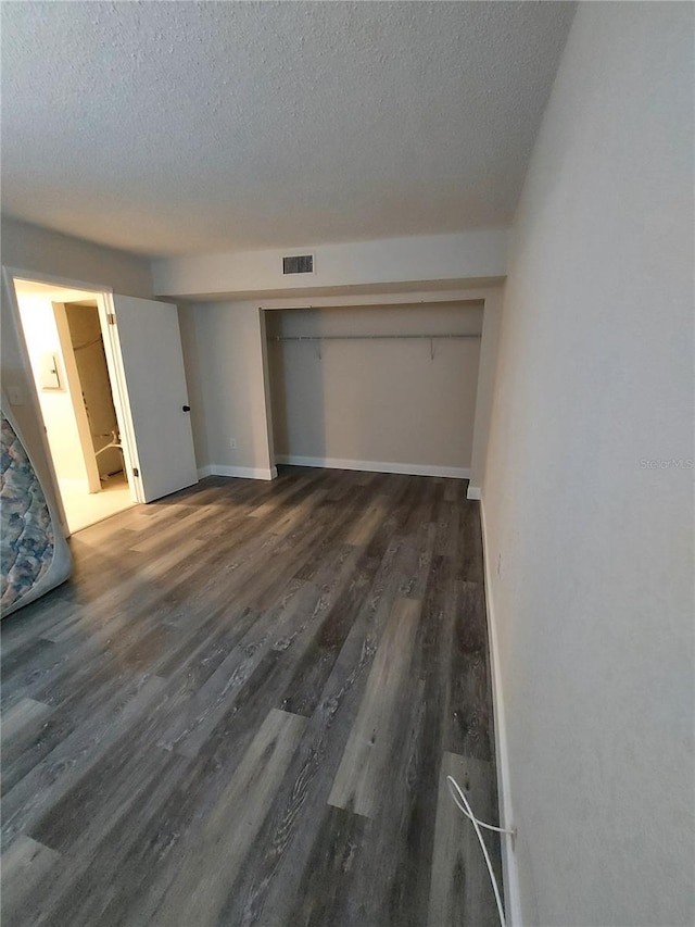 10033 64th Ave N Unit 9, Saint Petersburg, FL 33708 - unfurnished bedroom with a textured ceiling and wood finished floors