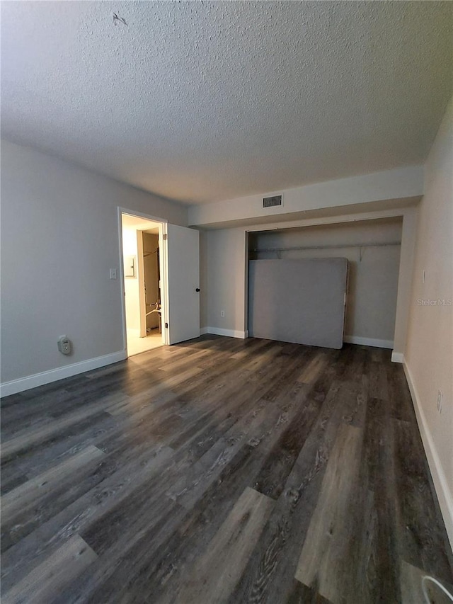 10033 64th Ave N Unit 9, Saint Petersburg, FL 33708 - spare room with a textured ceiling and wood finished floors