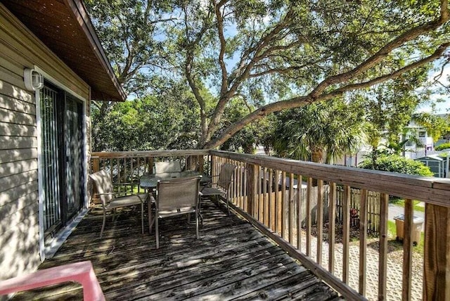 wooden deck featuring outdoor dining area