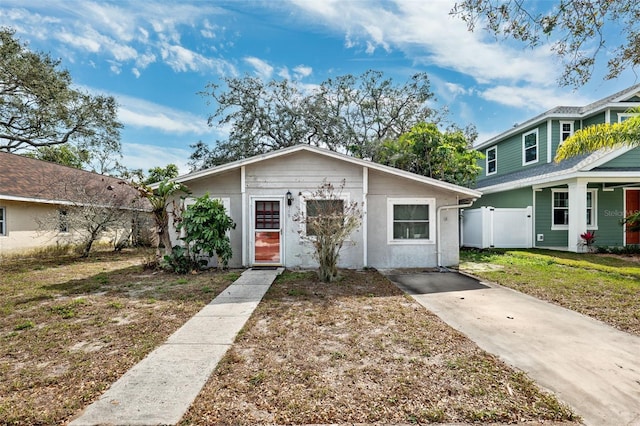 view of front of home featuring a front yard, fence, and a gate