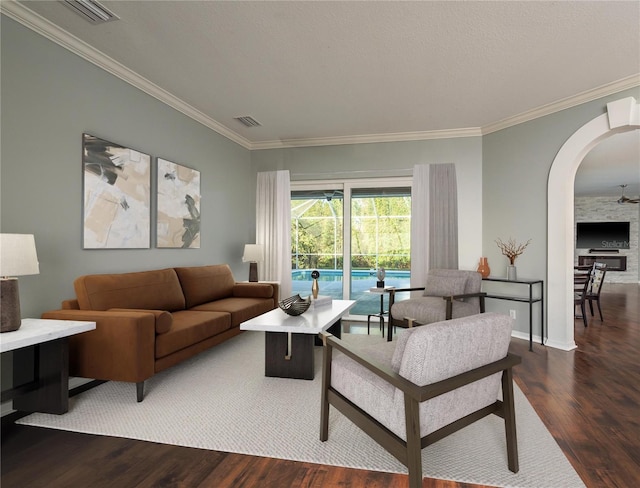 10537 Greensprings Dr, Tampa, FL 33626 - living room featuring arched walkways, wood finished floors, crown molding, and baseboards