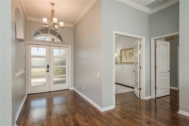 10537 Greensprings Dr, Tampa, FL 33626 - foyer with french doors, a chandelier, dark wood finished floors, crown molding, and baseboards
