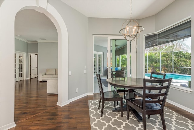 10537 Greensprings Dr, Tampa, FL 33626 - dining area featuring french doors, wood finished floors, plenty of natural light, arched walkways, and ornamental molding