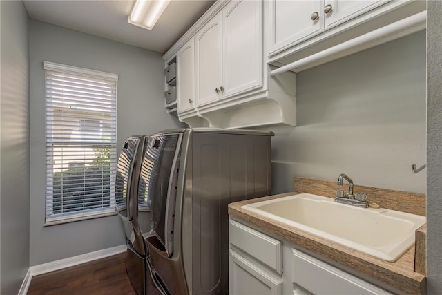 10537 Greensprings Dr, Tampa, FL 33626 - laundry area with cabinet space, dark wood-style floors, independent washer and dryer, and baseboards