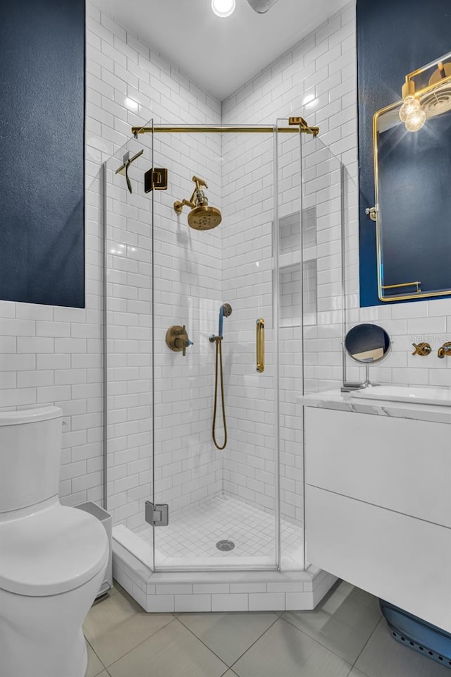 bathroom with tile patterned flooring, vanity, and a shower with shower door