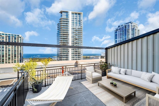 balcony featuring a water view and outdoor lounge area