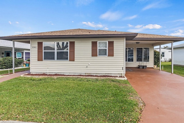 view of front facade with a carport and a front lawn