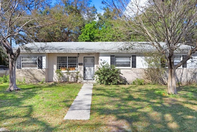 ranch-style home with a front lawn