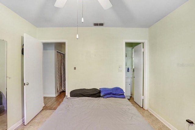 bedroom with ensuite bath and ceiling fan