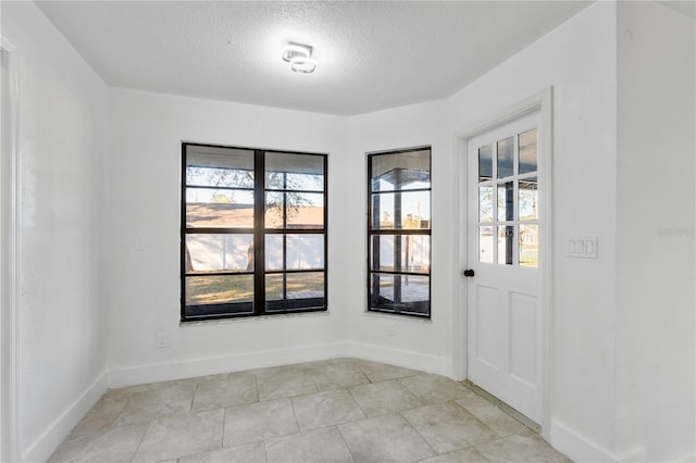 spare room with a textured ceiling