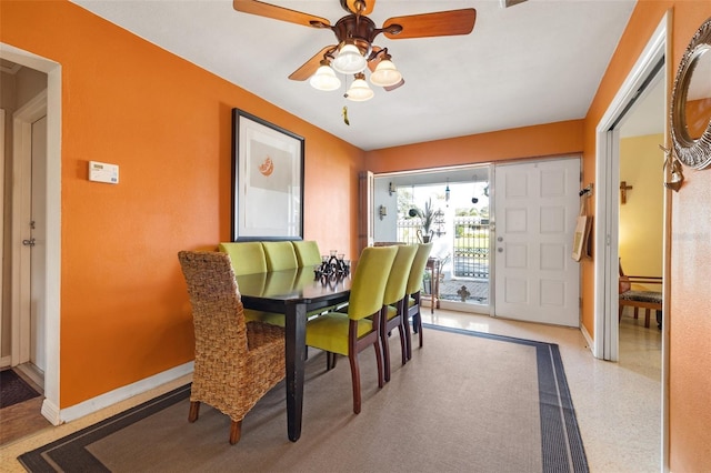 dining room with ceiling fan and baseboards