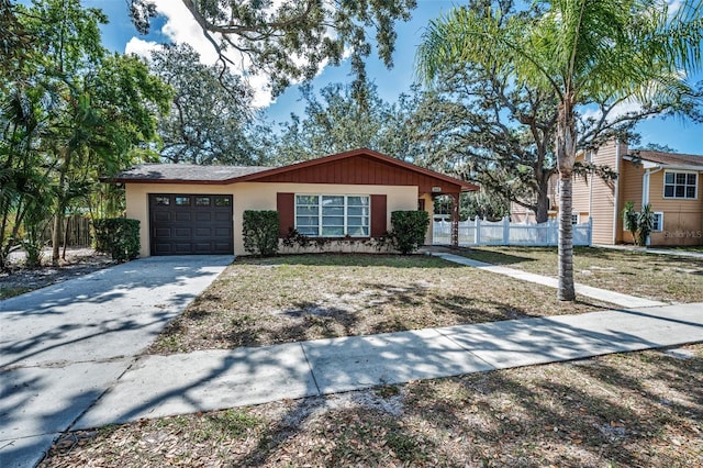 single story home with a front yard and a garage