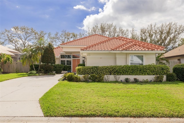 mediterranean / spanish house with a front lawn