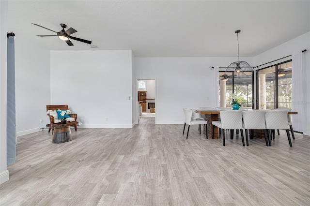 dining room with ceiling fan and light hardwood / wood-style flooring