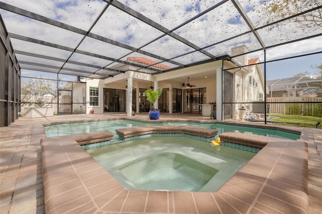 view of pool featuring a patio, an in ground hot tub, ceiling fan, and glass enclosure