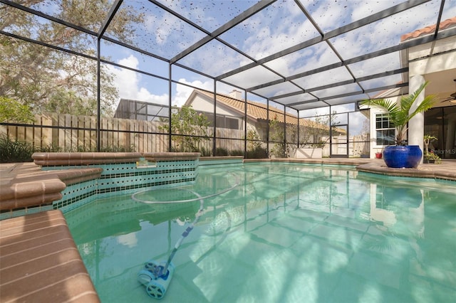 view of swimming pool featuring glass enclosure