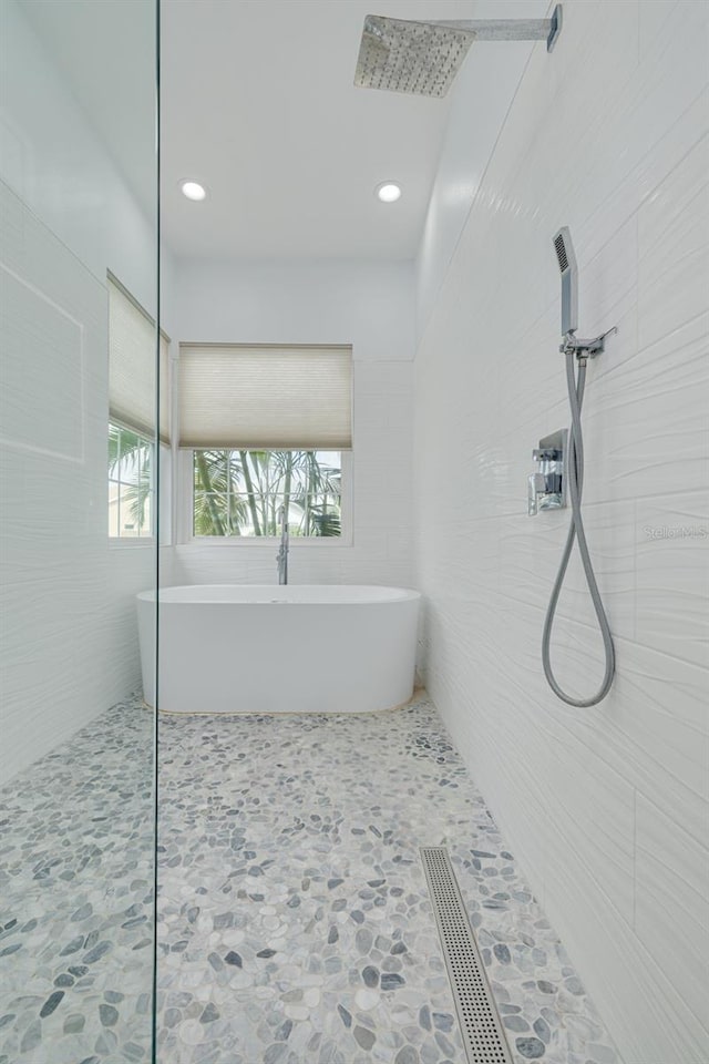 bathroom with a tub to relax in