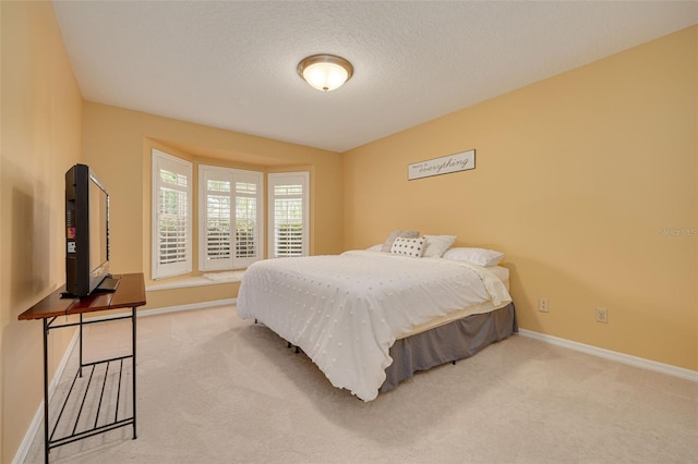 carpeted bedroom with a textured ceiling