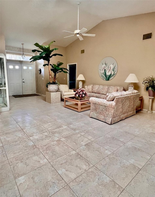 living room with ceiling fan and high vaulted ceiling