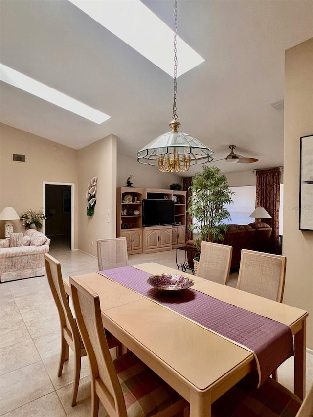 tiled dining room featuring lofted ceiling