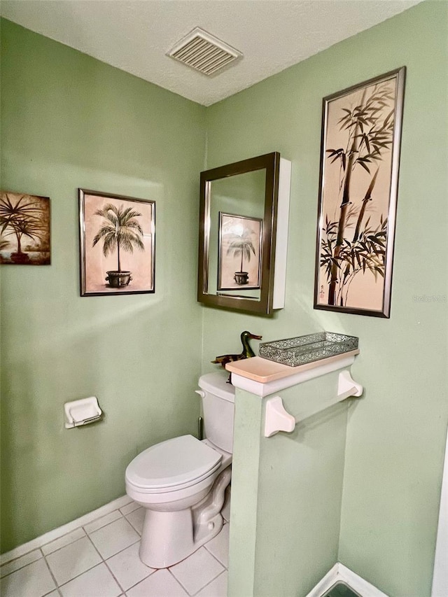 bathroom with tile patterned flooring and toilet