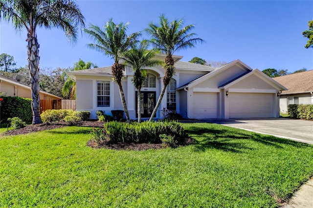 view of front of property with a garage and a front yard