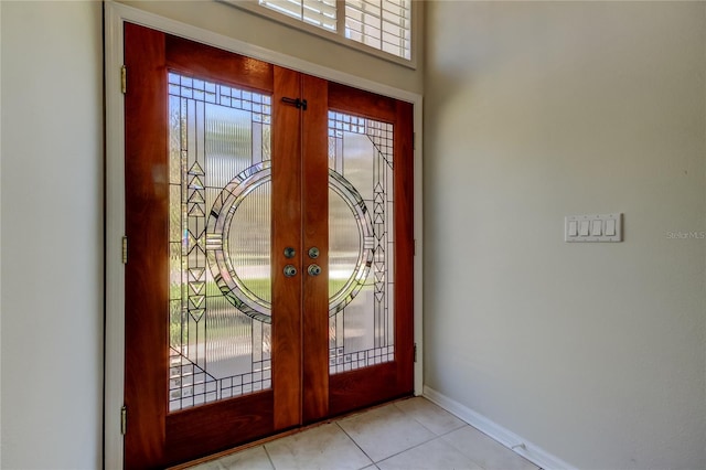 entryway featuring light tile patterned floors and french doors