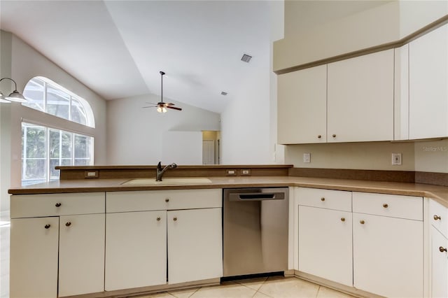 kitchen featuring white cabinetry, sink, stainless steel dishwasher, and lofted ceiling