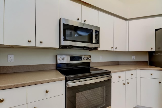 kitchen with white cabinetry and appliances with stainless steel finishes