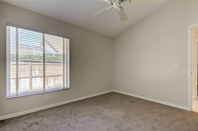 empty room with lofted ceiling, carpet, and ceiling fan