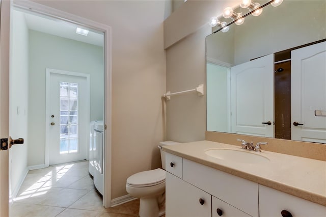 bathroom featuring washer and dryer, tile patterned floors, toilet, and vanity